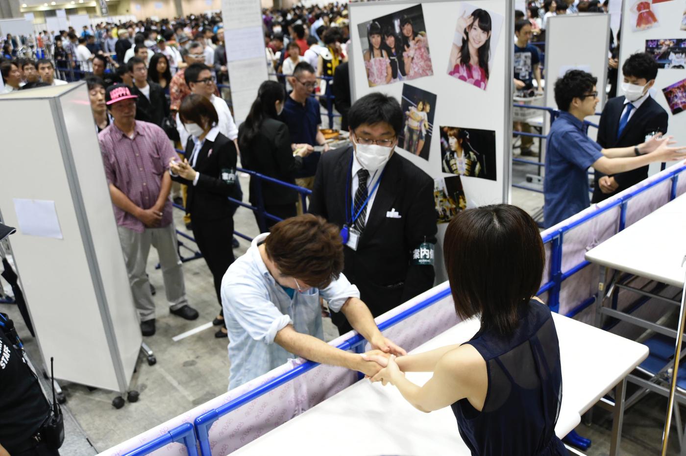 A devoted fan meeting a popular Japanese idol at a handshake event